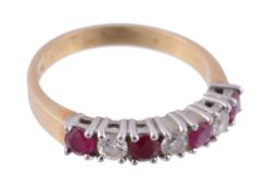 An 18 carat gold ruby and diamond seven stone ring  An 18 carat gold ruby and diamond seven stone