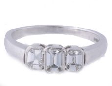 A diamond three stone ring, set with three rectangular shaped diamonds in...  A diamond three