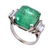 An emerald and diamond ring, the step cut emerald, estimated to weigh 8  An emerald and diamond