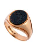 An 18 carat gold bloodstone signet ring, the oval bloodstone panel carved...  An 18 carat gold
