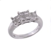 A platinum and diamond ring, set with four square cut diamonds in a four...  A platinum and