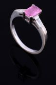 A pink sapphire and diamond ring , the rectangular mixed cut sapphire...  A pink sapphire and