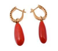 A pair of coral drop earrings, the polished pear shaped coral drop suspended...  A pair of coral