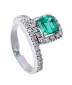 An emerald and diamond dress ring , the step cut emerald with canted corners...  An emerald and
