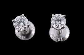 A pair of single stone diamond ear studs by Tiffany & Co  A pair of single stone diamond ear studs