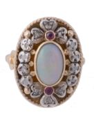 An opal, ruby and diamond ring, the central oval shaped opal collet set...  An opal, ruby and