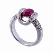 A ruby and diamond dress ring, the oval cut ruby suspension set within a...  A ruby and diamond