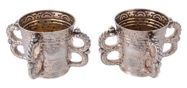 Two Edwardian silver gilt four-handled communal cups by R. & S. Garrard & Co. (Sebastian Henry