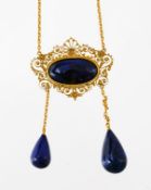An Italian lapis lazuli necklace, the oval cabochon lapis lazuli within an openwork scroll and