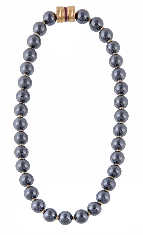 A hematite bead necklace, the thirty four uniform 10mm polished hematite beads with metal spacers