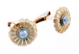 A pair of diamond flower head cufflinks by Mark Gold, the central collet set brilliant cut