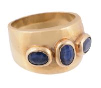 A three stone sapphire dress ring, the oval sapphires in raised collet...  A three stone sapphire