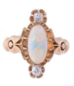 An opal and diamond ring, the central oval shaped opal between two old cut...  An opal and diamond