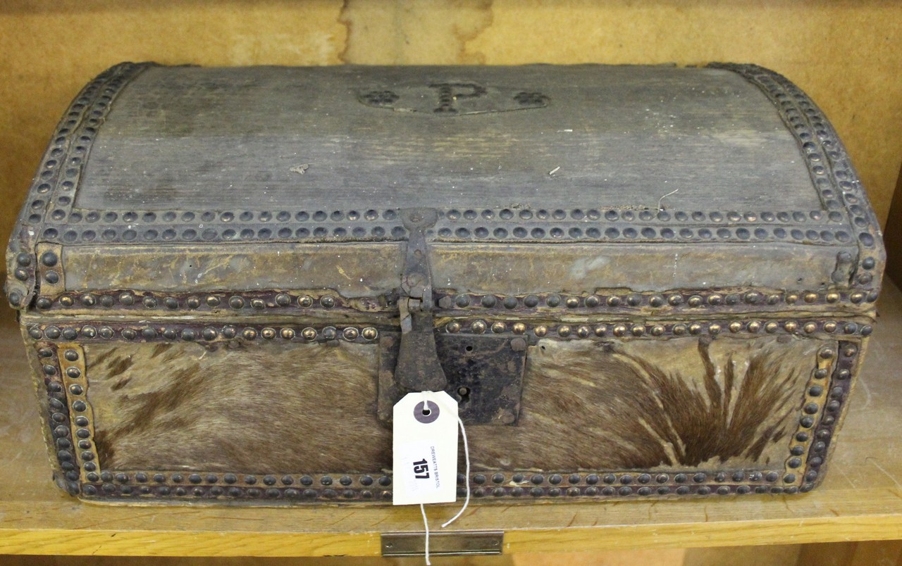 A 19th Century pony skin domed trunk, metal studded, initialled P to lid, with hoop carrying