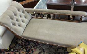 A Victorian walnut and upholstered chaise longue, the scrolling rest and galleried back above a