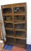 An oak five section book case with hinged glazed doors.