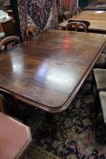 A Victorian mahogany extending dining table with an additional leaf, the top with a moulded edge