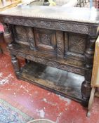 A 19th Century oak court cupboard with heavily carved panels 119cm high, 127cm wide