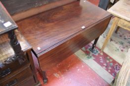 An early 19th century mahogany drop leaf table with reeded tapering legs