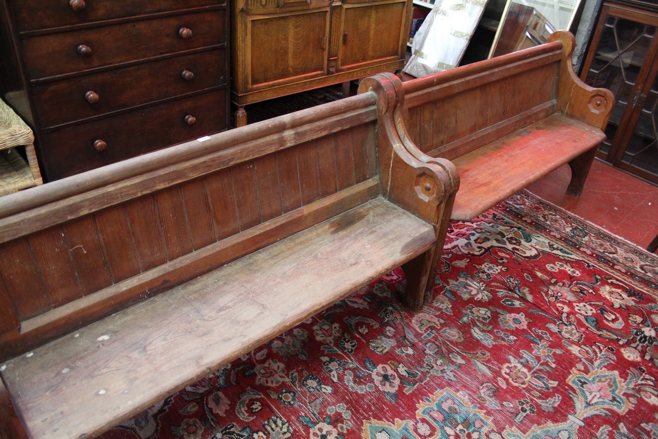 A pair of Victorian pitch pine church pews. Each 145cm wide.