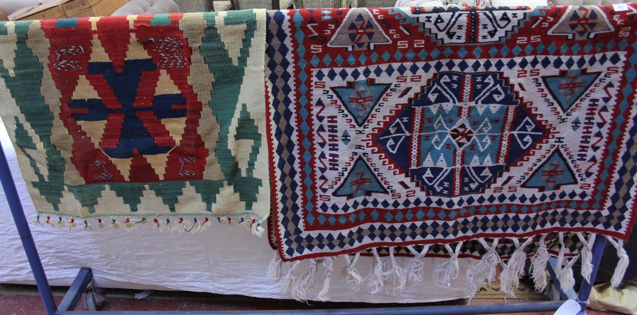 Two woven mats or wall hangings