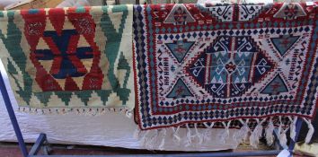 Two woven mats or wall hangings