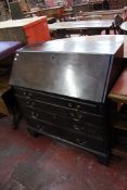 A George III mahogany bureau with four long drawers on bracket feet