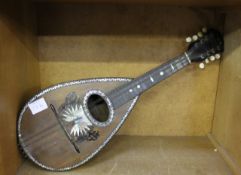 A Mandolin by Domenico Zanoni with mother of pearl inlay and an Armstrong saxophone in fitted