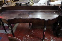 A Regency mahogany serving table, the gallery above shaped top with a central concave drawer flanked