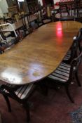 A Regency style mahogany twin pedestal dining table with one additional leaf and eight dining