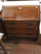 An Edwardian mahogany and crossbanded bureau with three long drawers