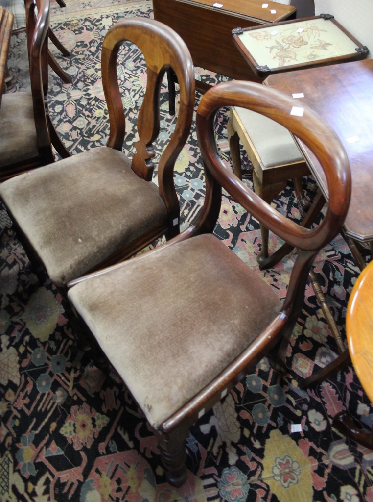 A set of six Victorian mahogany balloon back dining chairs each with a vase shaped splat and