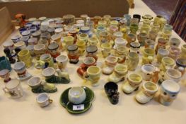 A large collection of assorted egg cups, to include Carlton Ware