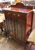 A mahogany display cabinet with a frieze drawer and astragal glazed doors