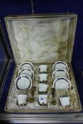 A 20th century cased set of six Limoges porcelain coffee cans and saucers, blue borders with gilt