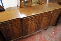 A Georgian style mahogany breakfront sideboard, four drawers over cabinets. Best Bid