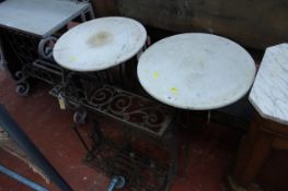 A pair of marble topped garden tables and a wrought iron hall stand