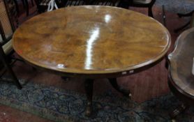 * A Victorian burr walnut oval table on turned column and floral carved legs 135cm wide