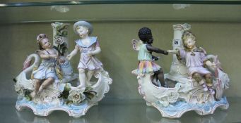 A pair of French porcelain boat shaped centrepieces, flower encrusted, with fairy figures, marked
