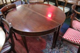 A pair of 19th Century mahogany and inlaid demi lune tables on square tapering legs and spade feet