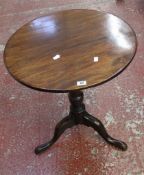 A George II mahogany tripod table the circular top above a turned stem and triple downswept cabriole