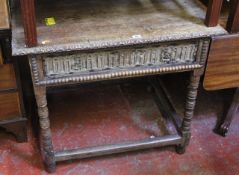A Victorian carved oak side table on ring turned legs joined by stretchers