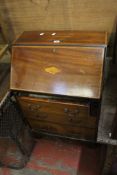 A mixed lot to include an Edwardian mahogany bureau and occasional table, a fender, two mahogany