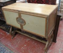 A pine cupboard circa 1930, standing on lyre shaped legs, possibly French, 107cm high, 122cm wide