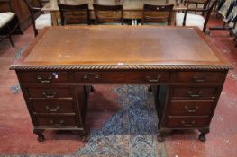 A Georgian style mahogany pedestal desk with nine drawers on short carved cabriole legs 153cm wide