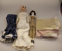 A Victorian doll with cloth body and bisque head, 29cm; another doll; and a quantity of doll`s