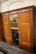 An Edwardian triple door wardrobe with central mirror with fitted interior 210cm high, 198cm wide