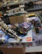 A quantity of built or partially built Lego vehicles and boxes of Lego bricks. Best Bid