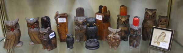 A small collection of carved wooden models of owls, some brush holders, and a framed owl print, (