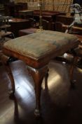 A walnut stool in the 18th century style with drop in seat on cabriole legs